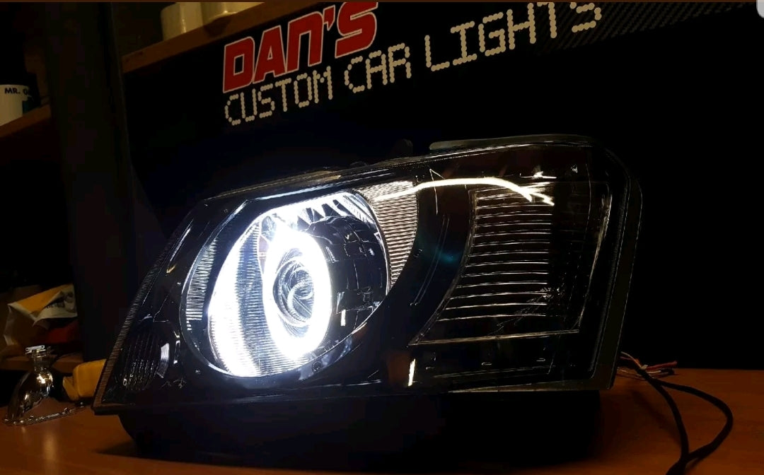 Nissan Patrol GU S4 Headlights with White/Amber Halo Rings and Projectors - Dan's Custom Car Lights 