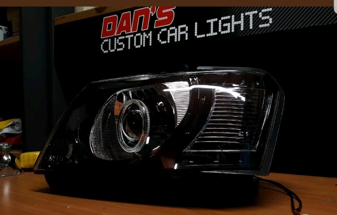 Nissan Patrol GU S4 Headlights with White/Amber Halo Rings and Projectors - Dan's Custom Car Lights 