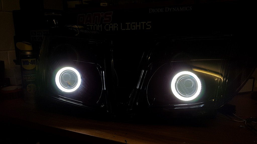 Nissan Navara D40 Thai Headlights Blacked out with Halo Rings and Projectors - Dan's Custom Car Lights 