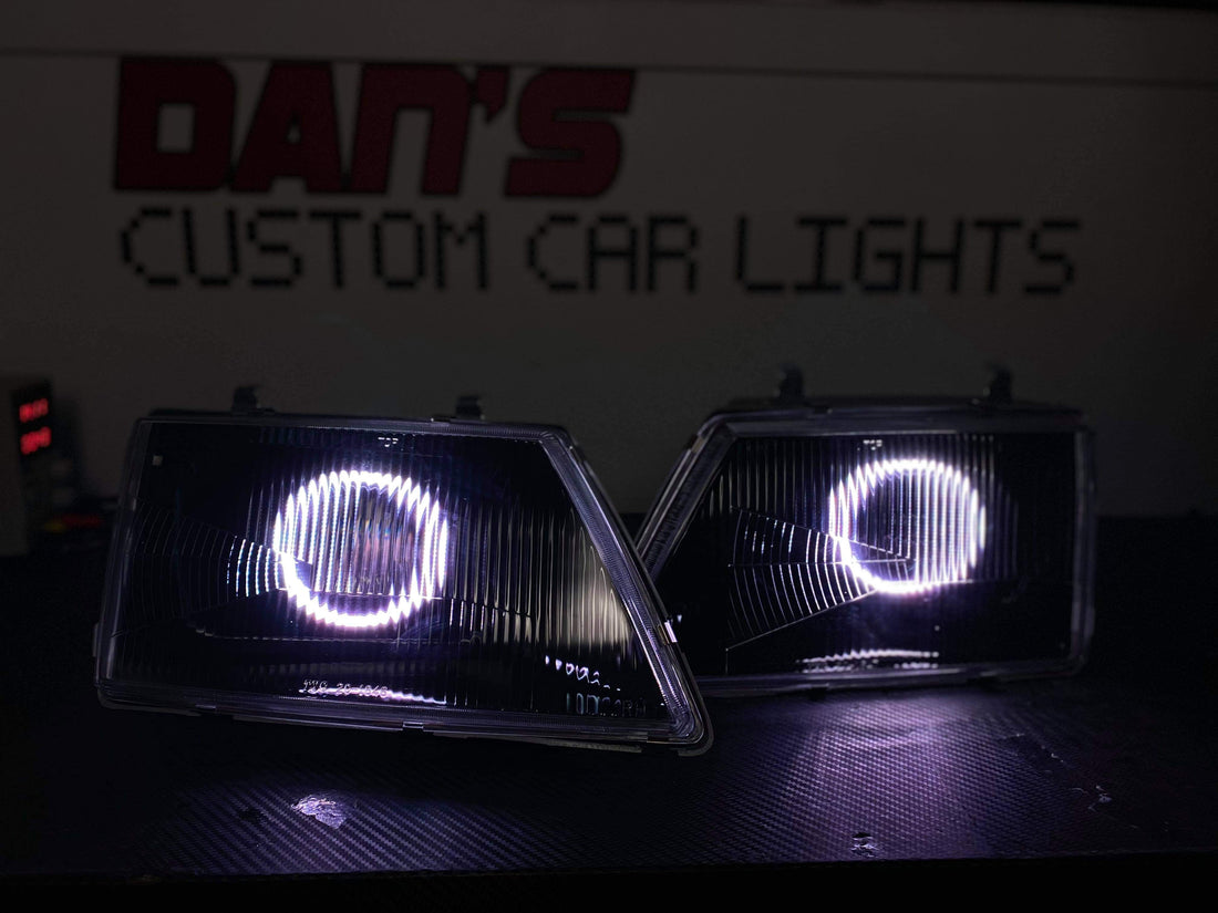 Holden VH Commodore With Projectors And Multicoloured Halo Rings Blacked Out - Dan's Custom Car Lights 